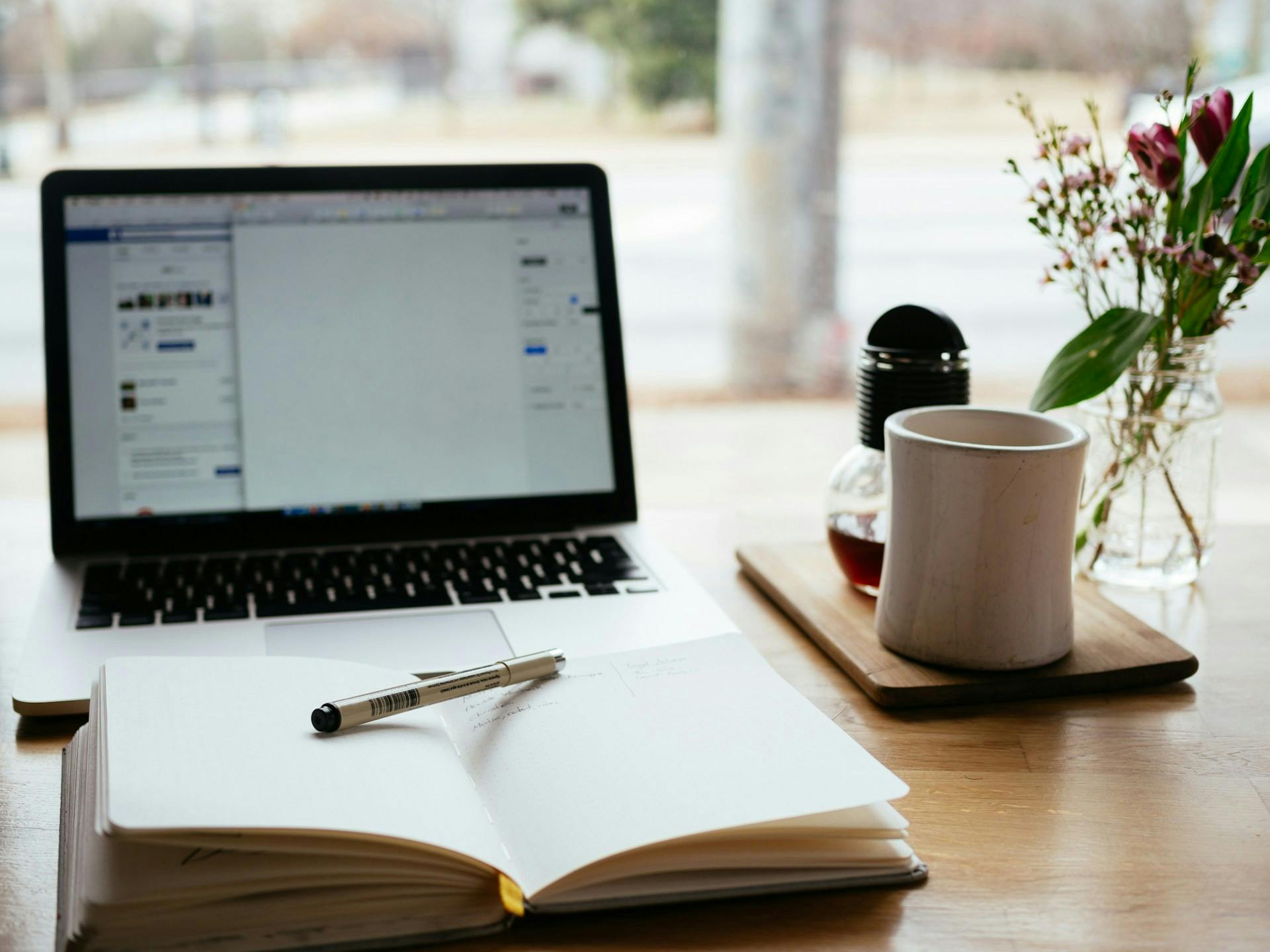Taking notes with notebook and laptop